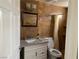 Bathroom features a modern vanity with granite countertops, a decorative mirror, and tiled walls at 3320 S Fort Apache Rd # 139, Las Vegas, NV 89117