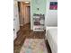 Bedroom view features hardwood flooring, a colorful rug, and a bookshelf with books and decorative items at 3320 S Fort Apache Rd # 139, Las Vegas, NV 89117