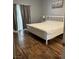 Bedroom with white framed bed, hardwood floors, natural light, and neutral wall paint at 3320 S Fort Apache Rd # 139, Las Vegas, NV 89117