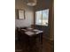 Inviting dining area features a wood table set for four, creating a welcoming space for meals at 3320 S Fort Apache Rd # 139, Las Vegas, NV 89117