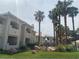 Beautiful Condo Community with palm trees, grass, and well maintained landscaping with an attractive entrance and inviting design at 3320 S Fort Apache Rd # 139, Las Vegas, NV 89117