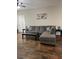 Spacious living room with wood floors, sectional sofa, coffee table, side tables, and elegant decor at 3320 S Fort Apache Rd # 139, Las Vegas, NV 89117