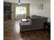 Living room features a cozy fireplace, wood flooring and a large sectional for relaxation and style at 3320 S Fort Apache Rd # 139, Las Vegas, NV 89117