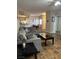 Comfortable living room featuring wood floors, sectional sofa and an open view to the kitchen and dining area at 3320 S Fort Apache Rd # 139, Las Vegas, NV 89117