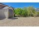 Backyard features gravel throughout, a shed, and privacy landscaping at 334 Cougar Estates Ln, Las Vegas, NV 89123