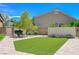 Well-manicured backyard featuring lush artificial grass and mature landscaping at 334 Cougar Estates Ln, Las Vegas, NV 89123