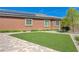 Beautiful backyard with manicured landscaping and artificial grass at 334 Cougar Estates Ln, Las Vegas, NV 89123