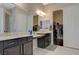 Bathroom showcasing dual sink vanity, walk-in shower, and a walk-in closet at 334 Cougar Estates Ln, Las Vegas, NV 89123
