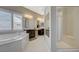 Modern bathroom with a walk-in shower, soaking tub, and dual sink vanity at 334 Cougar Estates Ln, Las Vegas, NV 89123
