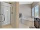 Bathroom featuring a soaking tub, walk-in shower, and modern fixtures at 334 Cougar Estates Ln, Las Vegas, NV 89123