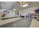 A spacious garage with epoxy flooring, storage racks and work area at 334 Cougar Estates Ln, Las Vegas, NV 89123