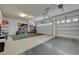 Spacious garage with epoxy flooring, storage racks and two garage doors at 334 Cougar Estates Ln, Las Vegas, NV 89123