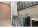 Laundry room with side by side washer and dryer and utility sink at 334 Cougar Estates Ln, Las Vegas, NV 89123
