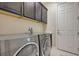 Laundry room featuring a side-by-side washer and dryer, as well as overhead cabinets at 334 Cougar Estates Ln, Las Vegas, NV 89123