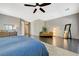 Expansive main bedroom featuring hardwood floors, a ceiling fan, and a full-length mirror at 334 Cougar Estates Ln, Las Vegas, NV 89123