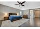 Large main bedroom with hardwood floors, a ceiling fan, and an en suite bathroom at 334 Cougar Estates Ln, Las Vegas, NV 89123