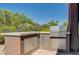Outdoor kitchen featuring a built-in grill, countertop and stainless steel storage at 334 Cougar Estates Ln, Las Vegas, NV 89123