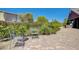 Charming brick patio with lush landscaping, chairs, and outdoor kitchen area, perfect for relaxing and entertaining at 334 Cougar Estates Ln, Las Vegas, NV 89123