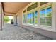 Covered patio with stone pavers and access to the backyard at 334 Cougar Estates Ln, Las Vegas, NV 89123