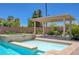 Beautiful outdoor pool and spa area with an inviting patio and covered seating at 334 Cougar Estates Ln, Las Vegas, NV 89123