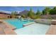 Stunning pool with a raised jacuzzi, stone accents, and a tranquil backyard setting, ideal for relaxation and recreation at 334 Cougar Estates Ln, Las Vegas, NV 89123