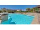 Inviting pool area with shimmering water, patio, and desert landscaping for serene outdoor living at 334 Cougar Estates Ln, Las Vegas, NV 89123
