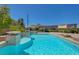 Refreshing pool area with a sun shelf and luxurious stone features at 334 Cougar Estates Ln, Las Vegas, NV 89123