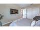 Cozy bedroom featuring a large TV and a comfortable chair, creating an inviting space to relax at 3778 Via Gennaro, Henderson, NV 89044