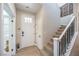 Bright foyer showcasing a staircase and a stylish front door with glass inserts at 3778 Via Gennaro, Henderson, NV 89044