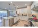 The modern kitchen opens to the living area and boasts stainless steel appliances, granite counters, and ample storage at 3778 Via Gennaro, Henderson, NV 89044