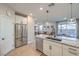Kitchen features stainless steel appliances, granite countertops, a breakfast bar, and an open layout to the living area at 3778 Via Gennaro, Henderson, NV 89044