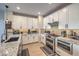 Modern kitchen features granite countertops, white cabinets, stainless steel appliances, and decorative backsplash at 3778 Via Gennaro, Henderson, NV 89044
