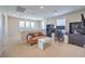Comfortable living area with large windows, modern furniture, and an office space at 3778 Via Gennaro, Henderson, NV 89044