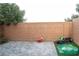 Private backyard featuring a brick wall, stone patio, and grassy area, perfect for outdoor activities and relaxation at 4178 Eagle Island St, Las Vegas, NV 89130
