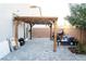 A backyard featuring a paved patio with a wood pergola, sliding glass doors, and block wall at 4178 Eagle Island St, Las Vegas, NV 89130