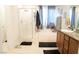 Bright bathroom featuring shower with glass door, soaking tub, and single sink vanity at 4178 Eagle Island St, Las Vegas, NV 89130