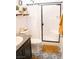 Bathroom featuring patterned floors, granite countertop, and tiled shower with glass door at 4178 Eagle Island St, Las Vegas, NV 89130