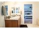 Well lit bathroom featuring double sinks, a large mirror and a view to a bedroom at 4178 Eagle Island St, Las Vegas, NV 89130