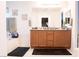 Bright bathroom with a double sink vanity, large mirror and tub with nautical themed decor at 4178 Eagle Island St, Las Vegas, NV 89130