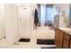 Bright bathroom featuring shower with glass door, soaking tub, and single sink vanity at 4178 Eagle Island St, Las Vegas, NV 89130