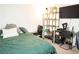 Bedroom with a bed, shelving unit with toys, desk, and a dark color scheme at 4178 Eagle Island St, Las Vegas, NV 89130