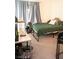 Bedroom features a bed with a green comforter and a desk with a gaming computer at 4178 Eagle Island St, Las Vegas, NV 89130