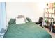 Bedroom featuring a bed with a green comforter, desk, and display shelf at 4178 Eagle Island St, Las Vegas, NV 89130