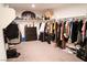 Walk-in closet with an oval Las Vegas Raiders sign, shelves and rods for lots of storage at 4178 Eagle Island St, Las Vegas, NV 89130
