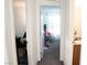 Hallway between rooms, revealing access to a bedroom and bathroom with ample lighting at 4178 Eagle Island St, Las Vegas, NV 89130