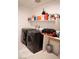 Functional laundry room with modern washer and dryer units, and a convenient storage shelf for supplies at 4178 Eagle Island St, Las Vegas, NV 89130