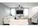 Bright living room features a mounted TV, a neutral color palette and plush seating at 4178 Eagle Island St, Las Vegas, NV 89130