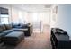 Cozy upstairs living area featuring a comfortable gray sectional sofa, neutral walls, and plenty of natural light at 4178 Eagle Island St, Las Vegas, NV 89130