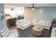 Bright living room includes two couches, ceiling fan and seamlessly connects to the kitchen and dining area at 4178 Eagle Island St, Las Vegas, NV 89130
