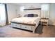 Inviting bedroom with a large bed, stylish nightstands, and ample natural light from the windows at 4178 Eagle Island St, Las Vegas, NV 89130